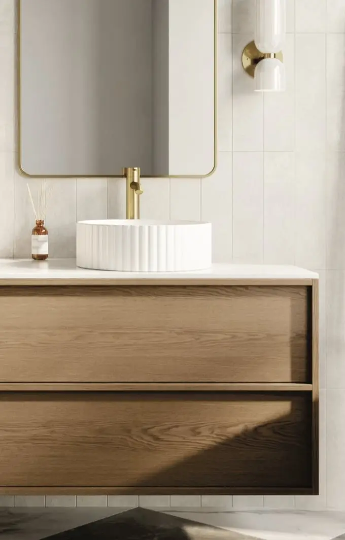 A Cabico bath vanity in oak with a fluted basin, brass tap and arched mirror